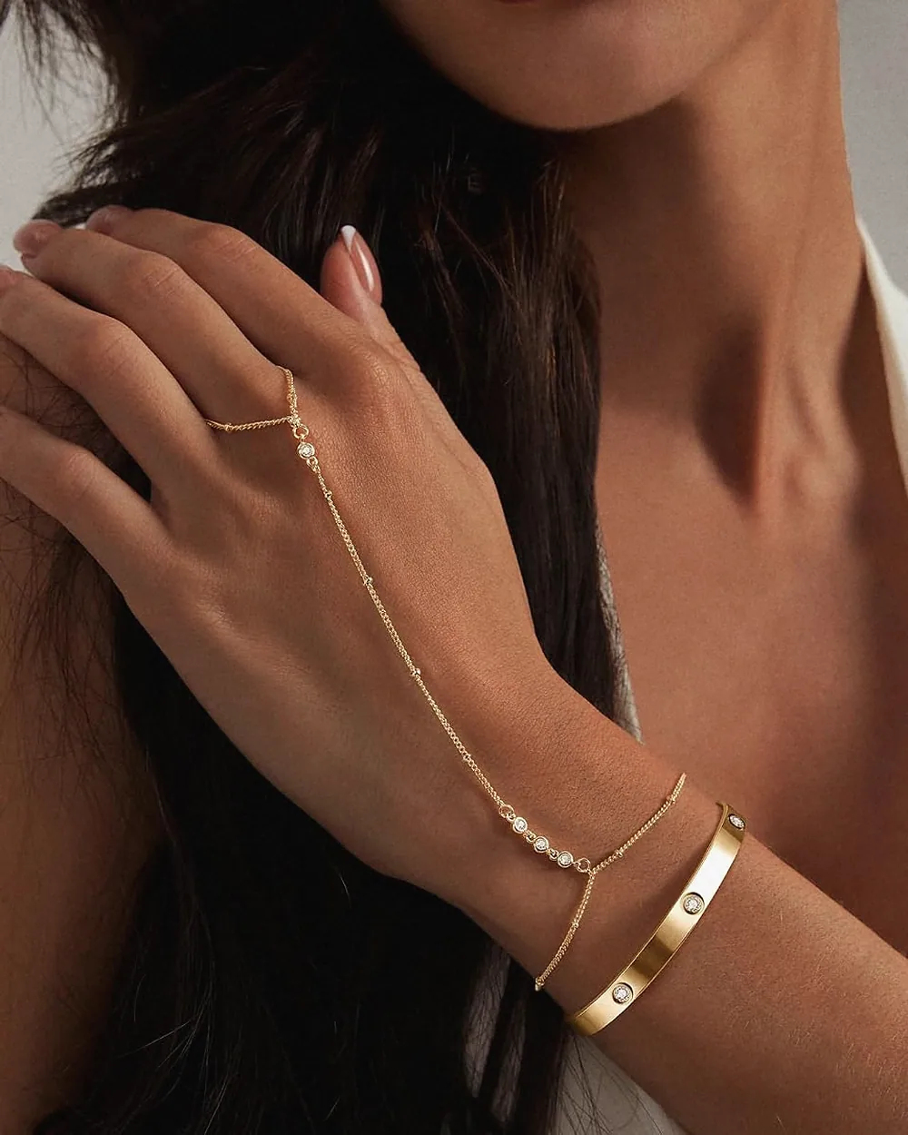 Hand chain and bangle worn on the wrist