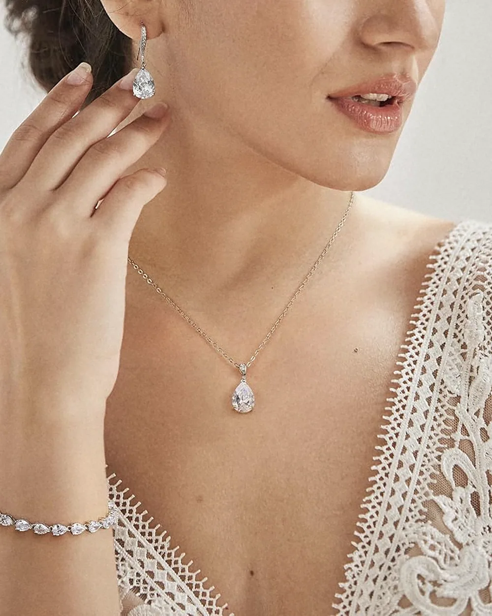Teardrop pendant worn with lace